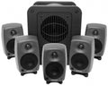Five small Genelec speakers and one larger subwoofer speaker arranged in a group.