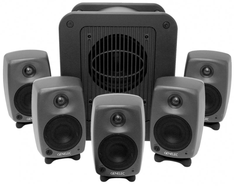Five small Genelec speakers and one larger subwoofer speaker arranged in a group.