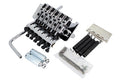 Silver metal locking tremolo bridge with arm, springs, cylinders, Allen wrench, and screws on white background.