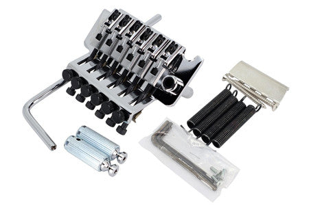 Silver metal locking tremolo bridge with arm, springs, cylinders, Allen wrench, and screws on white background.
