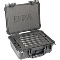 Five black cylindrical microphone-like devices arranged in foam inside an open black hard carrying case labeled DPA.