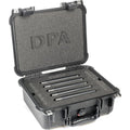 Five black cylindrical microphones neatly arranged in a black foam-padded hard carrying case embossed with DPA.