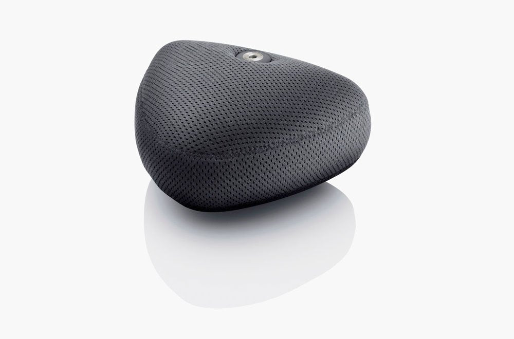 Black triangular microphone with a textured fabric surface and a metallic connector on top on a white background.