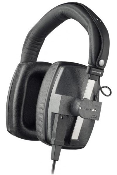 Black and gray over-ear headphones with padded headband and rectangular ear cups showing a wired cable and a rotary dial.