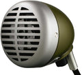 Round microphone with a silver grille and green metal casing connected to a cable with a coil protector.