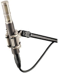 Black and silver microphone with shock mount and attached arm stand against white background.