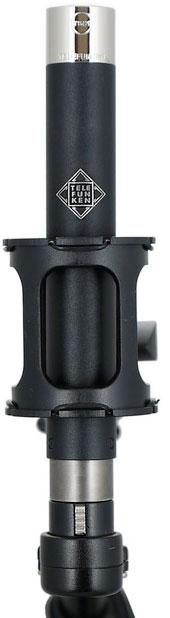 Black and silver microphone with TELEFUNKEN logo mounted in a black shock mount with a male XLR connector.