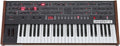 Top view of a black keyboard synthesizer with wooden side panels labeled prophet~6 and multiple control knobs and buttons.