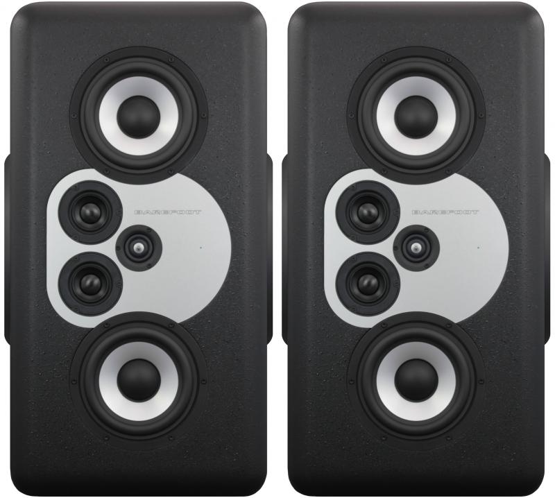 Front view of a pair of black studio monitor speakers with multiple speaker cones and silver highlights.
