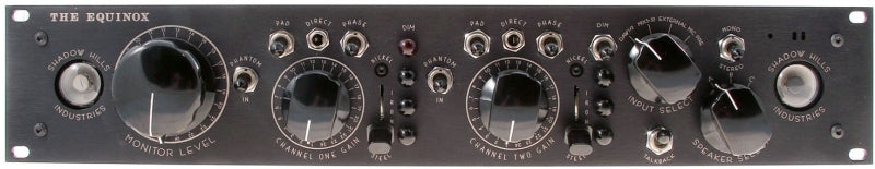 Black audio equipment panel with multiple knobs, switches, and two 1/4 inch jacks labeled for channel control.