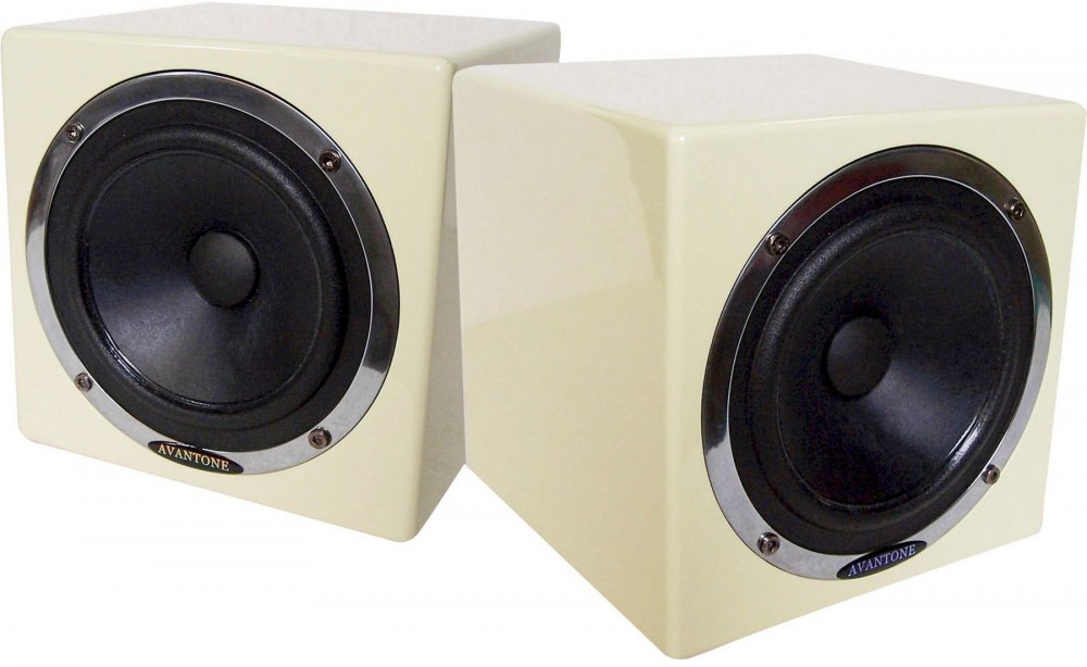Pair of cream-colored cube-shaped speakers with black drivers and silver rims on front