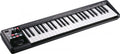 Black MIDI controller keyboard with white and black keys and various buttons and joystick controls on left side.