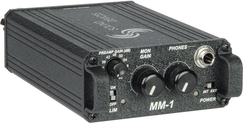 Black rectangular audio device with gain control knobs, toggle switches, and a headphone jack on front panel labeled MM-1.