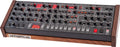 Black synthesizer module with wooden side panels, various knobs, buttons, LED displays, and a sequencer control section.