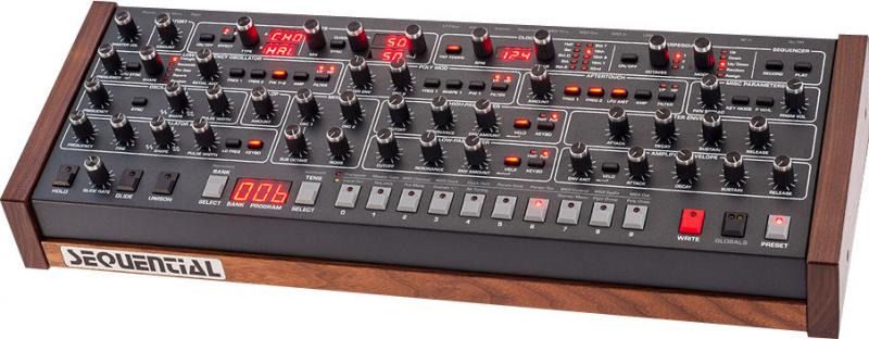 Black synthesizer module with wooden side panels, various knobs, buttons, LED displays, and a sequencer control section.