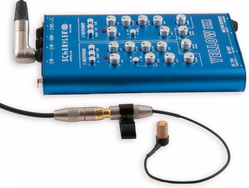 Blue audio control box with multiple knobs and two cable connectors attached to an acoustic pickup with a clip and cork mount.