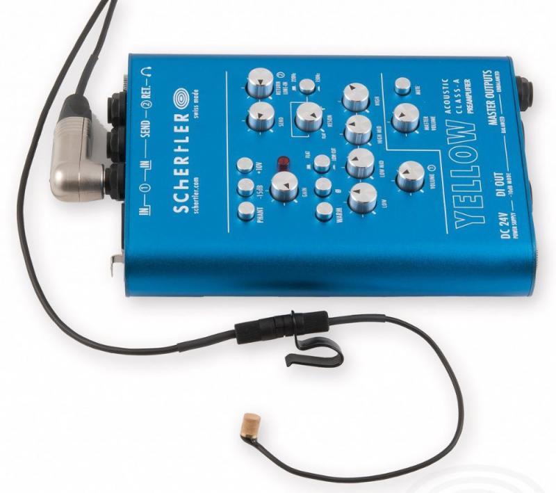 Blue Schertler audio preamplifier unit with attached headset-style microphone pickup on white background.
