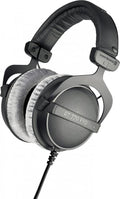 Over-ear black and gray headphones with fabric ear cushions and a coiled wired cable.