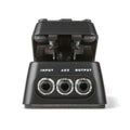 Black expression pedal showing input, aux, and output 1/4 inch audio jacks from front view.