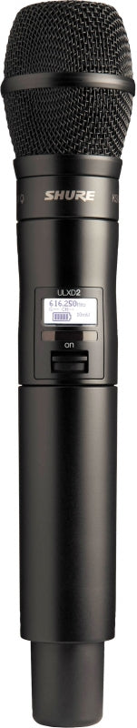 Black wireless handheld microphone with mesh grille and digital display showing frequency and power status.
