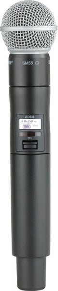 Black wireless handheld microphone with silver mesh grille and visible power switch and display.