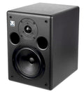 Black studio monitor speaker with two circular ports, a tweeter, and a woofer on the front panel.