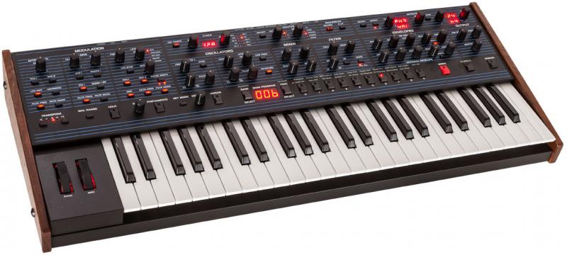 Black synthesizer keyboard with wooden side panels and various knobs, buttons, and sliders on the control panel.