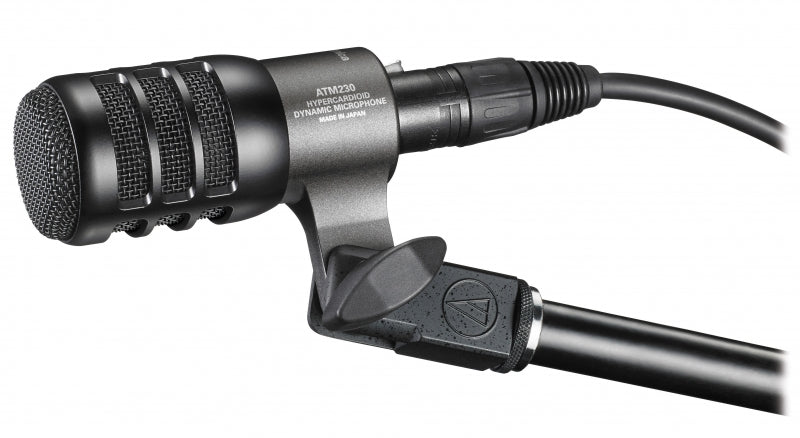 Black dynamic microphone labeled ATM230 hypercardioid with attached XLR cable and microphone clip.