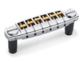 Chrome guitar bridge unit with six adjustable saddles and two mounting posts.