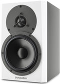 White studio monitor speaker with black circular drivers and DYNAUDIO branding on front.
