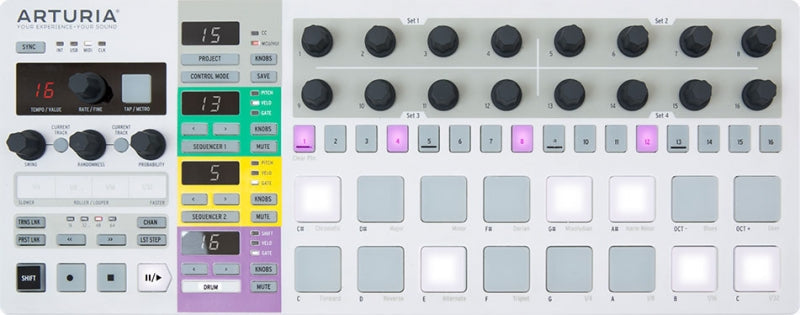 Top view of a white MIDI controller with pads, knobs, buttons, and colored labeled sections.