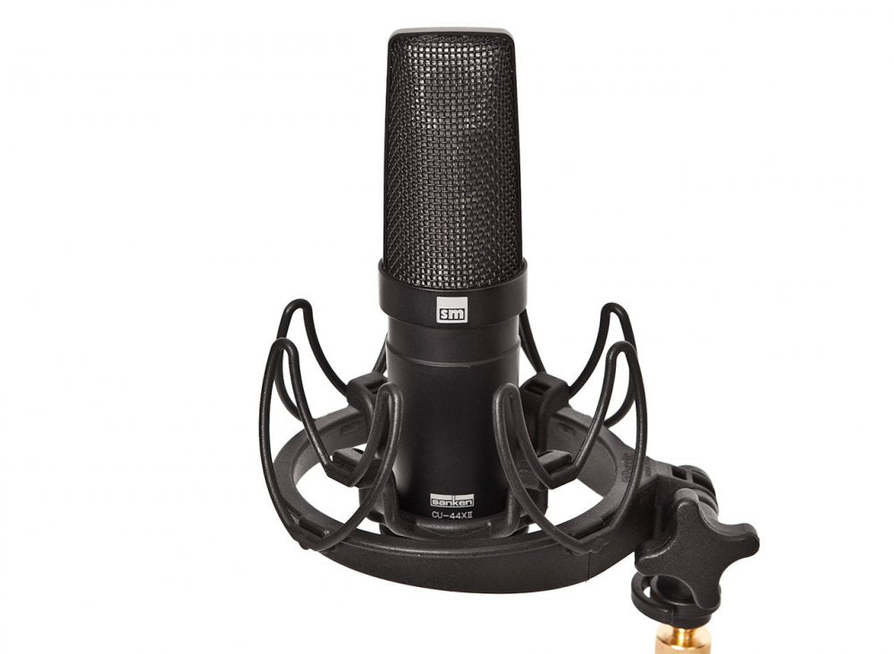 Black studio microphone labeled CU-44XII in a shock mount with a white background.