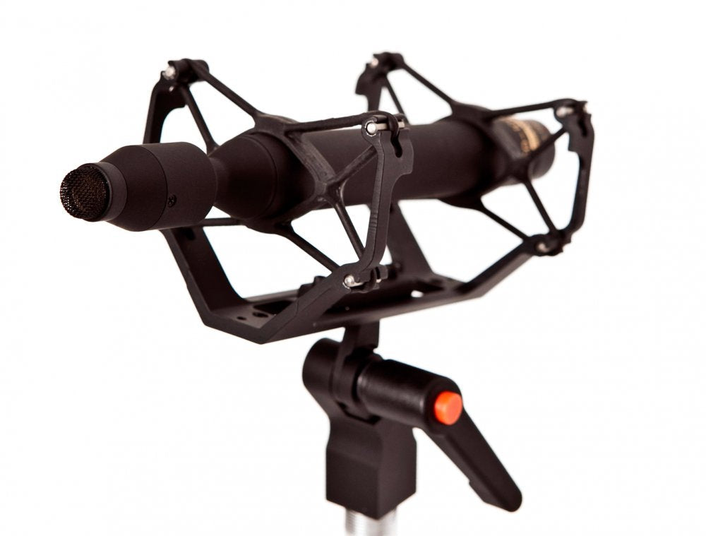 Black shotgun-style microphone mounted in a shock mount with a stand clip and an orange knob control.