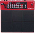 Top view of a red Nord Drum 3P drum machine with six black pads and various control buttons and knobs
