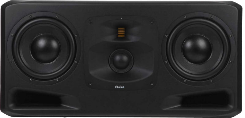 Front view of a black studio monitor speaker with two large drivers and one centered smaller driver below a ribbed element.