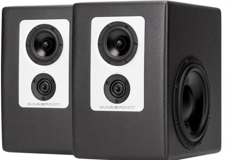 Pair of black studio monitors with white front panels and visible speaker cones.