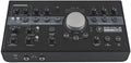 Black audio monitor controller interface with multiple knobs, buttons, and input/output jacks.