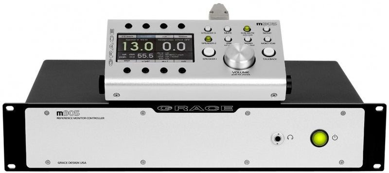 Rackmount monitor controller labeled m905 with a remote control device showing a digital display and buttons on top.