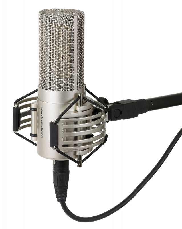 Silver condenser microphone with shock mount and cable attached, branded with audio-technica logo.