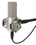 Silver condenser microphone with shock mount and cable attached, branded with audio-technica logo.