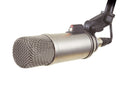Silver metal microphone with black mount and XLR connector shown on white background