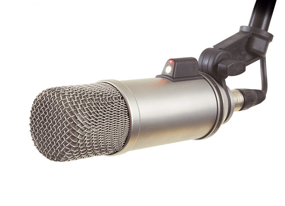 Silver metal microphone with black mount and XLR connector shown on white background