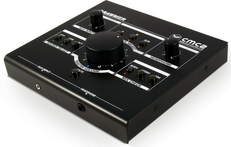 Black rectangular audio monitor controller with knobs, buttons, and 1/4 inch headphone and auxiliary inputs on front panel.