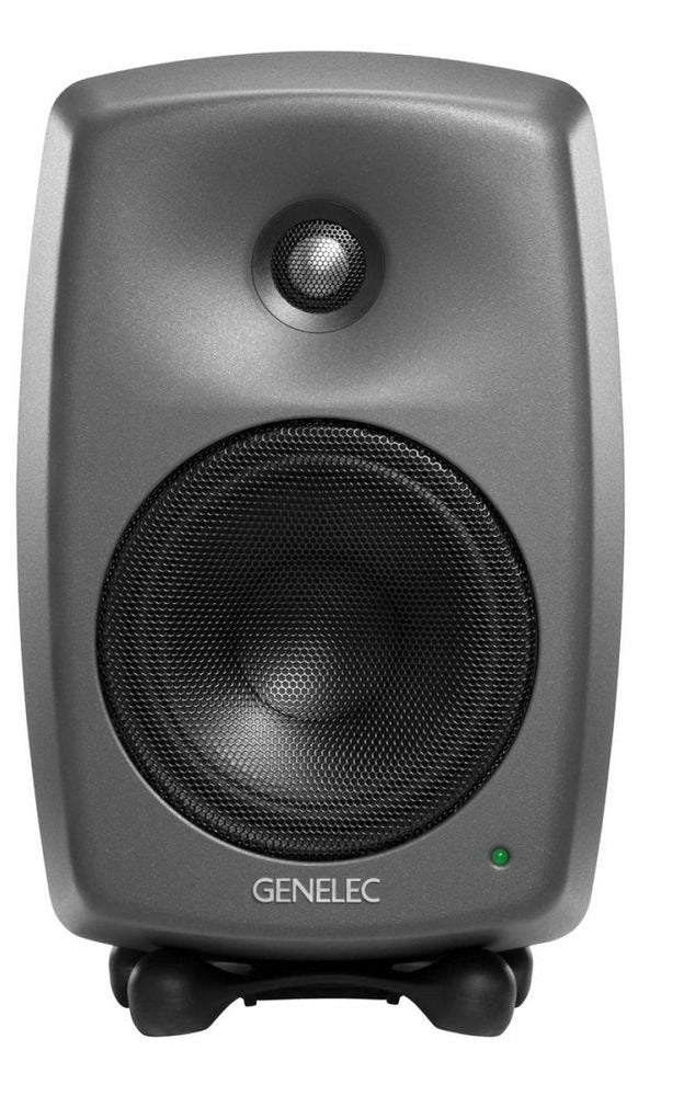 Front view of a black Genelec studio monitor speaker with metal speaker grilles and a green status LED indicator.