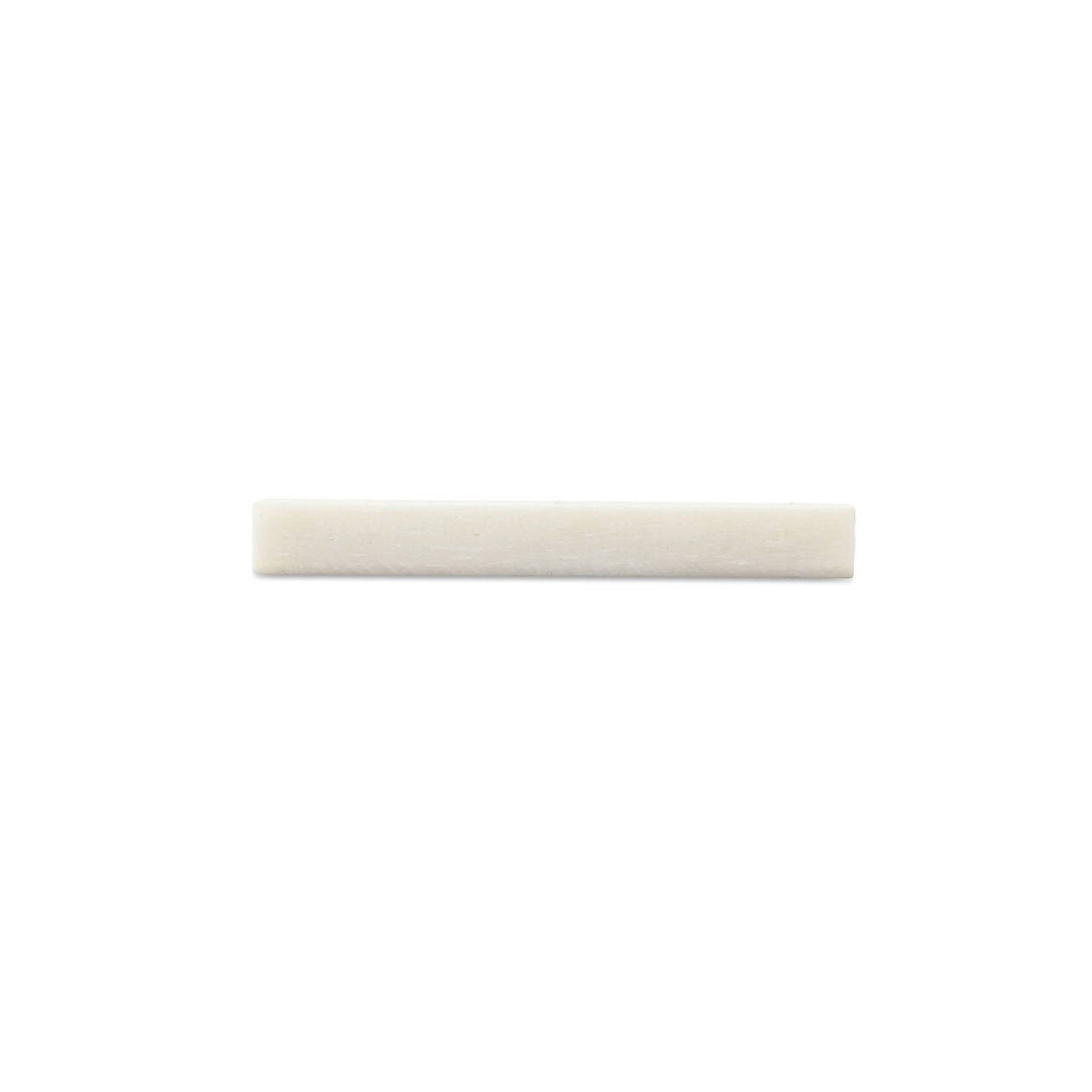 A small rectangular off-white blank nut piece on a white background.