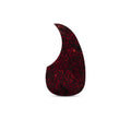 Tortoise-patterned guitar pickguard with a curved shape on white background.