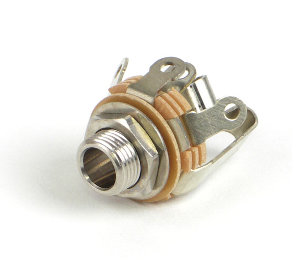 Close-up of a 1/4 inch stereo jack socket with mounting nut and beige insulating washers.