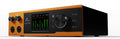 Front view of a black and orange audio device with a screen, knobs, buttons, and two combo input jacks.