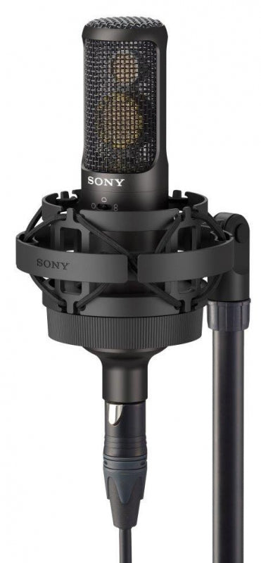 Black Sony microphone with shock mount and XLR cable attached on a stand.