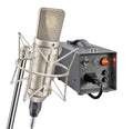 Large diaphragm condenser microphone in shock mount with metal power supply box featuring on/off switch and knobs